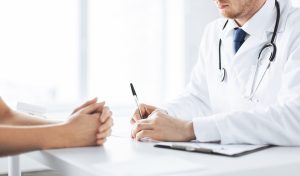close up of patient and doctor taking notes